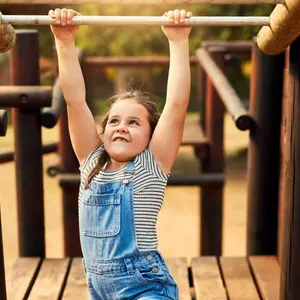 Girl, hanging the monkey bars 