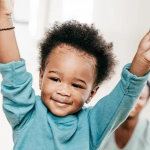Toddler with his hands in the air