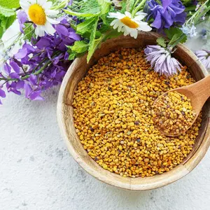 Bee pollen (not propolis) in a bowl with purple and white wildflowers