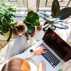 Woman and her cat sitting in her own home oasis