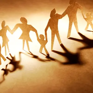 paper cut-outs of family members holding hands, forming a family constellation