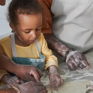 Small child learns how to bake in a teaching kitchen
