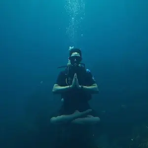 Person in lotus position while SCUBA diving