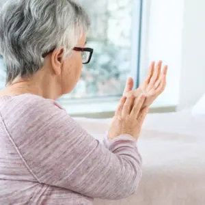 Senior woman struggling with Parkinson’s 