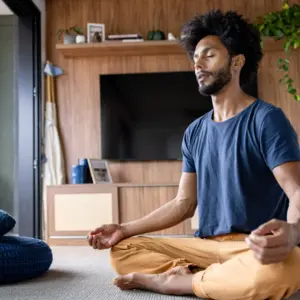 Man meditating at home