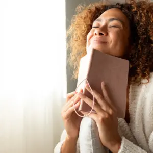 Woman manifesting in her journal