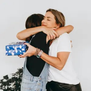 two women hugging, gratitude after receiving a gift
