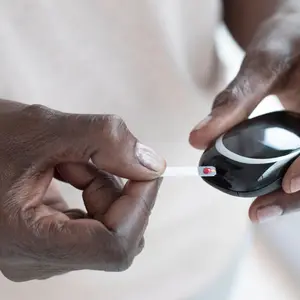 diabetes patient measures their blood glucose levels