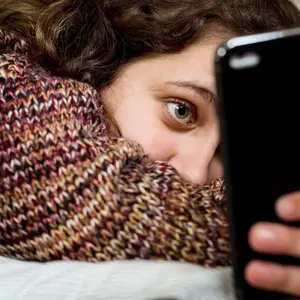 girl scrolling on her phone