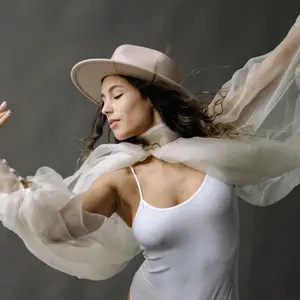 woman wearing white dancing creatively