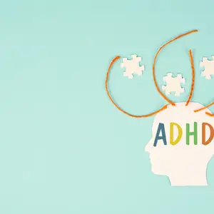 illustration of  brain labelled "ADHD" and rope tendrils emerging with puzzle pieces, sky-blue background