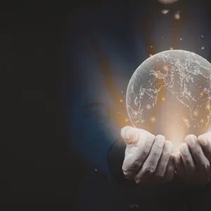 Image of hands on a black background holding a futuristic globe of interconnected nodes, signaling the future of medical research