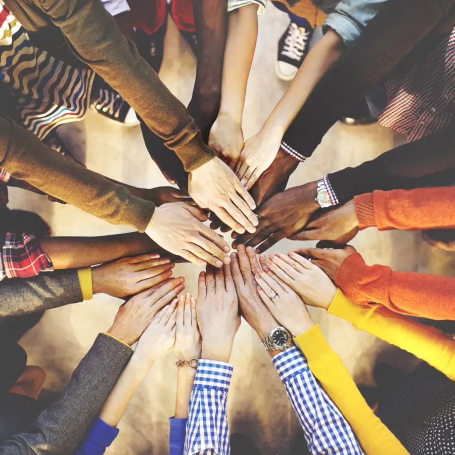 Arms reaching towards center of group